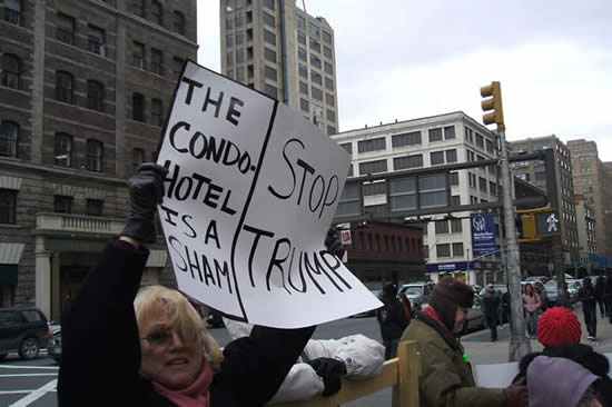 protester holds a sign at protest against proposed condo-hotel in SoHo
