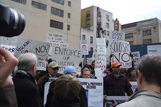 protesters hold signs at protest against proposed condo-hotel in SoHo